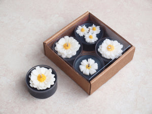 "Daisies on Black" Tealight Set - Unscented black soy candles decorated with wax daisies.