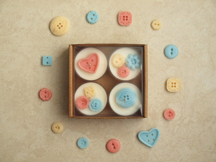Nursery Notions Tealight Set - Miscellaneous pastel wax buttons on four white tealight candles.