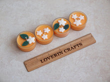 Load image into Gallery viewer, &quot;Orange Blossom&quot; Tealight Set - Unscented orange soy candles decorated with white wax flowers and green wax leaves.