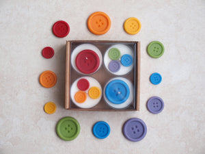 "Rainbow Buttons" Tealight Set - Colorful wax buttons on four white tealight candles.