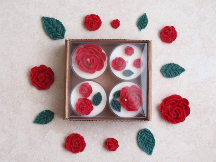 Red Roses Tealight Set - Red roses and deep green leaves on four white tealight candles.